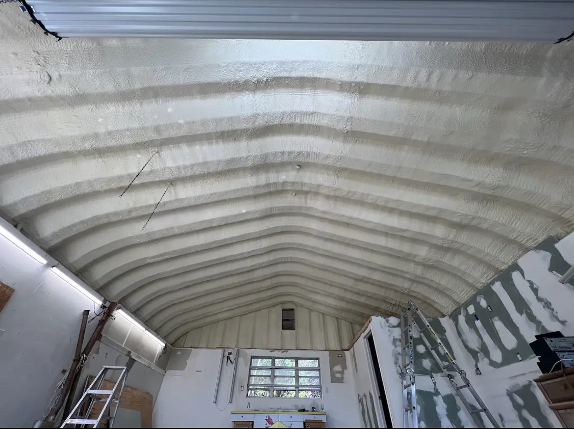 Spray polyurethane foam applied to the underside of a metal roof deck in Morganton